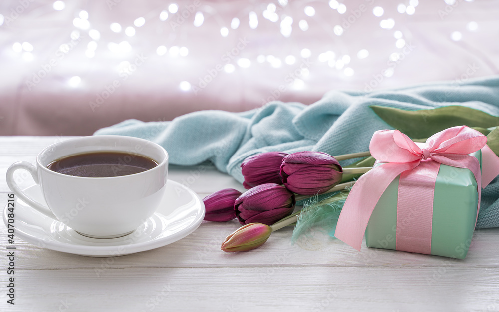Festive background with a cup of coffee, flowers . Side view, with space to copy. The concept of holiday backgrounds.
