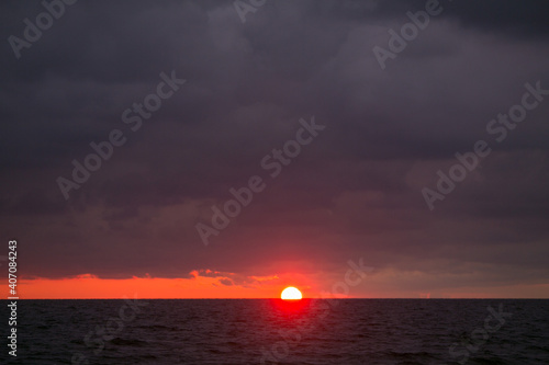 The sun is setting in the sea. © vov8000