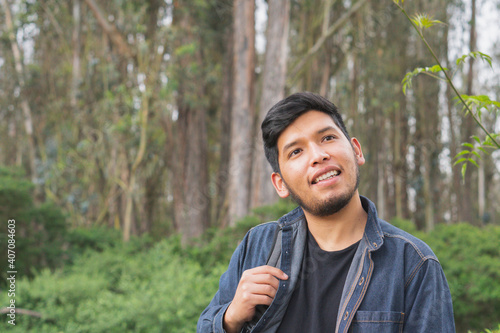 Young man walking in the woods.