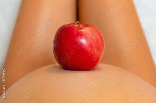 Pregnant woman eating healthy food. Red apple.