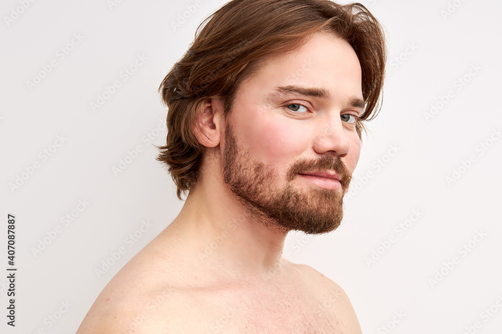 smiling shirtless man having bristle looking at camera, young caucasian male model isolated over white background. side view portrait smiling shirtless man having bristle looking at camera, young caucasian male model isolated over white background. side view portrait