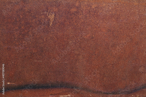Background of natural brown old saddle leather with spots