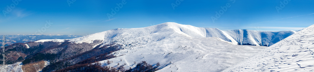 Winter mountains panorama with snowy peaks. Winter in the mountains