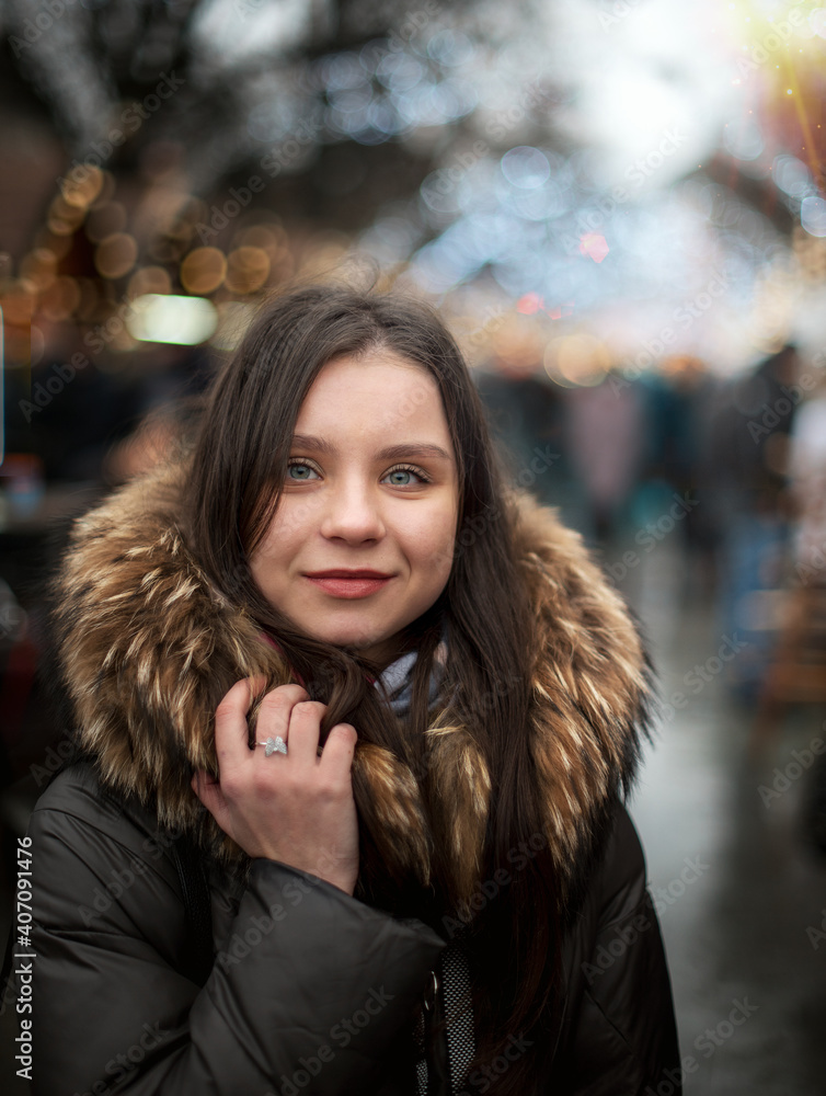 portrait of a beautiful girl walking at a festive winter fair. holiday mood. winter and rest. walks portrait of a beautiful girl walking at a festive winter fair. holiday mood. winter and rest. walks