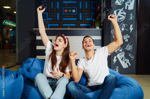 Emotional outburst. Real, genuine joy of two young guys of European appearance, who rejoice at their victory in the playstation or xbox games. Sharply raised their hands up and shout with joy