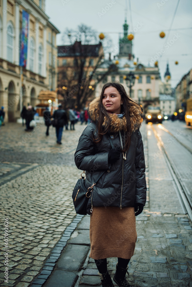 girl walks in the winter city. New Year's portrait of a girl celebrating the winter holidays. holiday mood. Christmas mood and rest