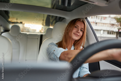 Portrait of smiling young girl sitting alone on driver seat