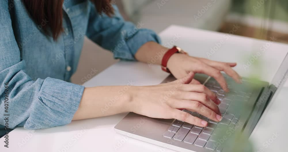 Close up shot of Caucasian female hands working on white modern computer typing and tapping on keyboard sitting at desk in cabinet, woman fingers texting on laptop, digital device, technology concept