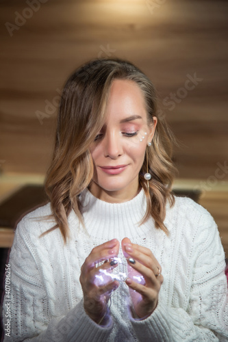 New Year's portrait of a girl with lights in her hands