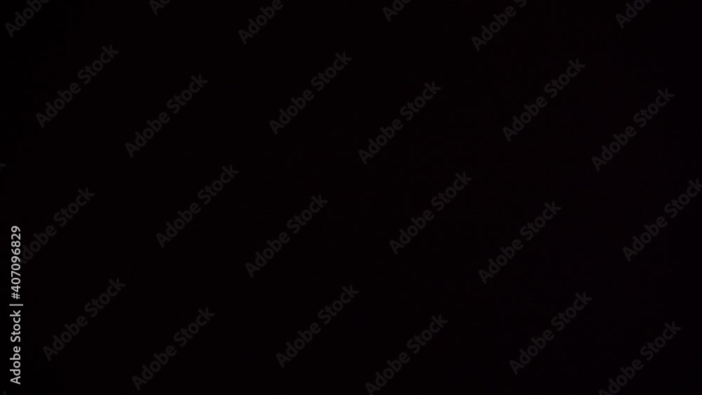 Narrow frame during New Year's celebration. Periodically bright lights from flares and other fireworks flash against a dark background. Narrow frame during New Year's celebration. Periodically bright lights from flares and other fireworks flash against a dark background.