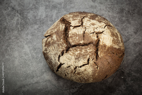 Rye bread with a crisp crust on a gray mottled background