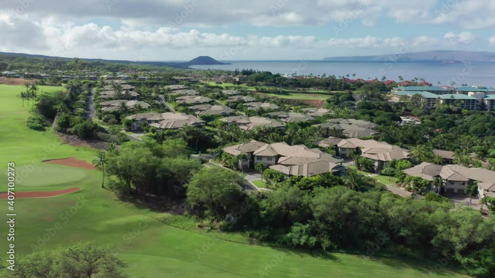 Aerial panorama of oceanfront luxury resort villas and cottages with golf course view on Maui Hawaii, USA. Landscape view of modern hotels buildings at green golf field on tropical island, 4K drone Aerial panorama of oceanfront luxury resort villas and cottages with golf course view on Maui Hawaii, USA. Landscape view of modern hotels buildings at green golf field on tropical island, 4K drone