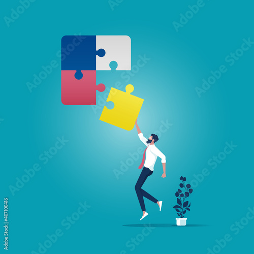 Business solving problems concept, Businessman connecting the last piece of jigsaw puzzle to complete the mission