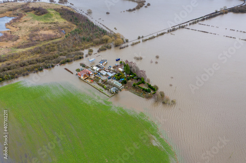 Aerial drone photo of the town of Allerton Bywater near Castleford in Leeds West Yorkshire showing the flooded fields and farm house from the River Aire during a large flood after a storm. photo