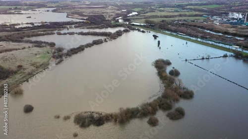 Aerial drone footage of the town of Allerton Bywater near Castleford in Leeds West Yorkshire showing the flooded fields from the River Aire on a rainy winters day during a large flood after a storm. photo