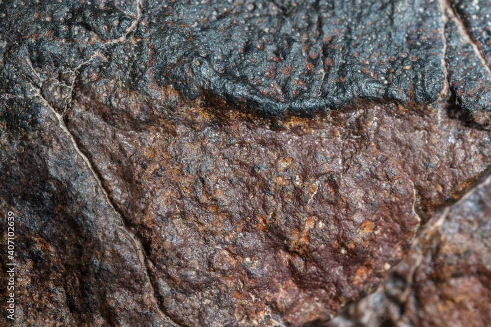 Macro photo of the fusion crust from a Chondrite Meteorite, piece of rock formed in outer space in the early stages of Solar System as asteroids. This meteorite comes from an asteroid fall at Atacama Macro photo of the fusion crust from a Chondrite Meteorite, piece of rock formed in outer space in the early stages of Solar System as asteroids. This meteorite comes from an asteroid fall at Atacama