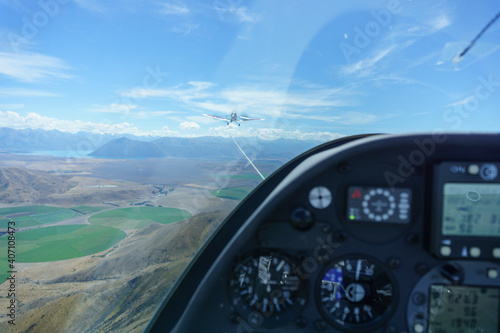View from with glider glider cockpit while under tow from tow-plane.