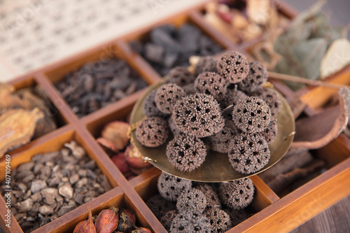 A box of all kinds of traditional Chinese medicine and maple balls on the box photo