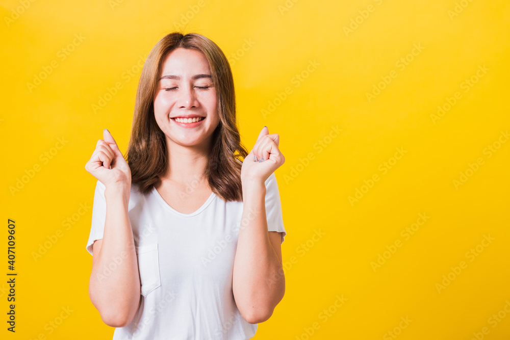 woman teen standing wear t-shirt makes raised fists up celebrating her success woman teen standing wear t-shirt makes raised fists up celebrating her success