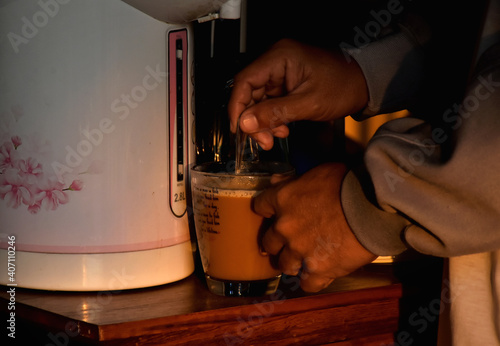 Hand of people brew coffee to drink in morning time isolated with dark background.