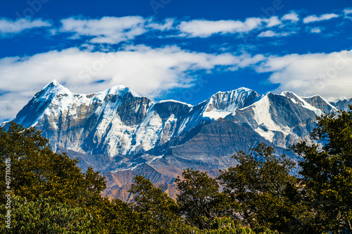 Mountains in the snow.  Scenic mystic view of Himalayan peaks such as Mt. Trishul, Mt Nanda Ghunti and Mt. Khamet. At an altitude of 3800 m. On way to  Bramhatal trek , Lohajung , Uttarakhand, India. photo