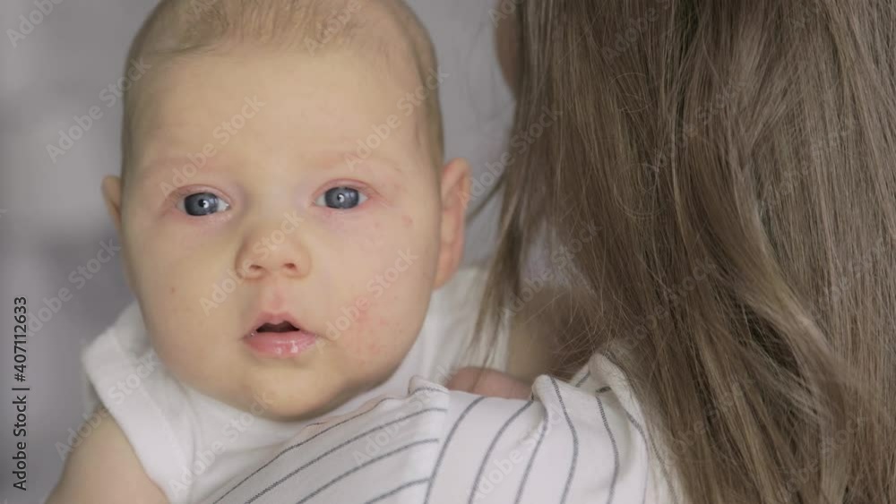 Portrait of a newborn baby, held by it's mother. Portrait of a newborn baby, held by it's mother.