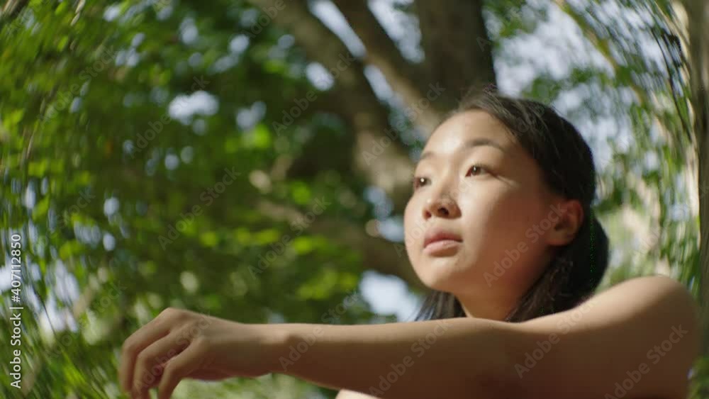 Slow motion video of a dancer performing an improved dance piece in the green forest during autumn. Slow motion video of a dancer performing an improved dance piece in the green forest during autumn.