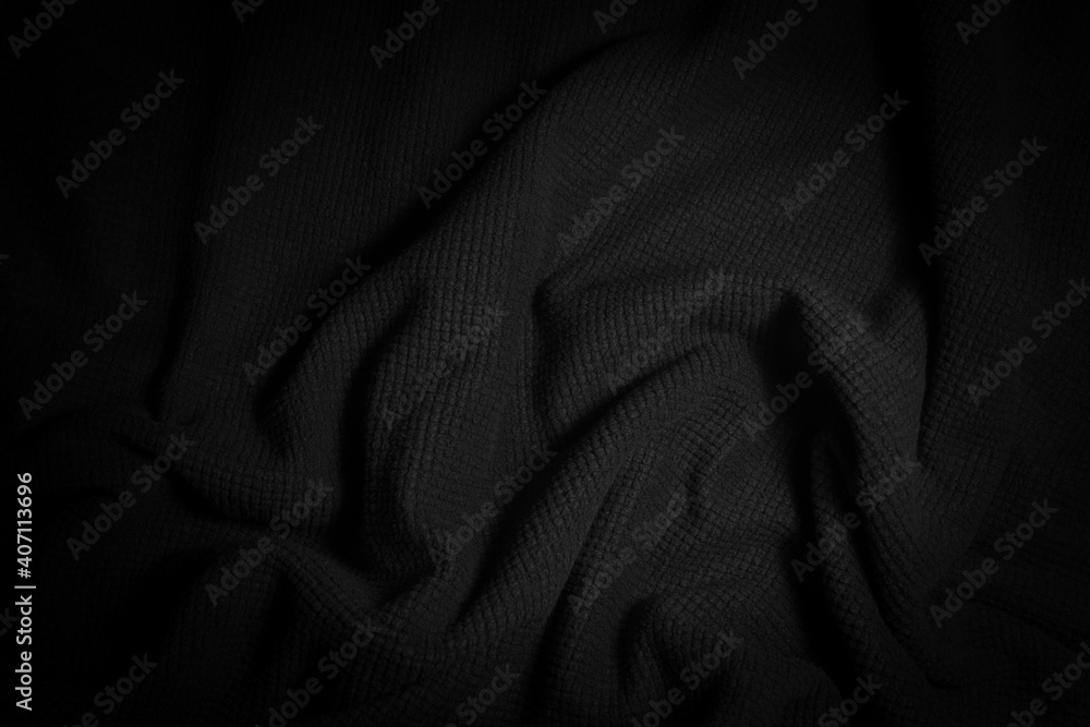 Fototapeta premium Abstract vignette folded black cloth background.