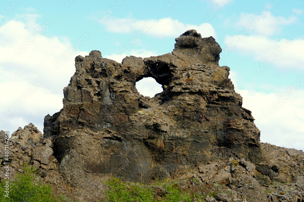 The view of the unique rock structure and the cave at Dimmuborgir Lava Formations near Lake Myvatn, Iceland
