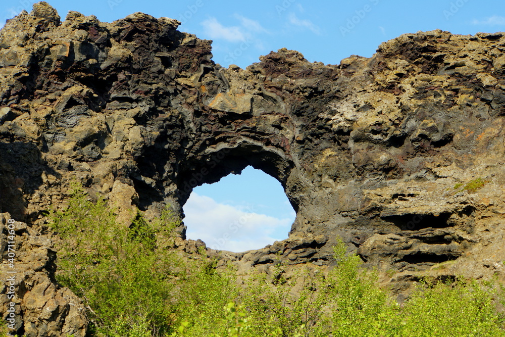 The view of the unique rock structure and the cave at Dimmuborgir Lava Formations near Lake Myvatn, Iceland in the summer