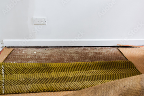 фотографія ripping up the carpet and underlay revealing floorboard in home interior renovat
