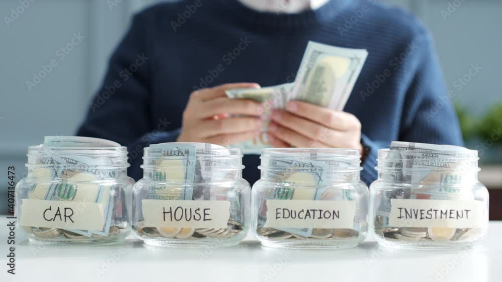 Hand's man putting money in jar for future, money plan, save money and management concept