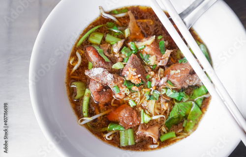 Braised beef with egg noodles soup