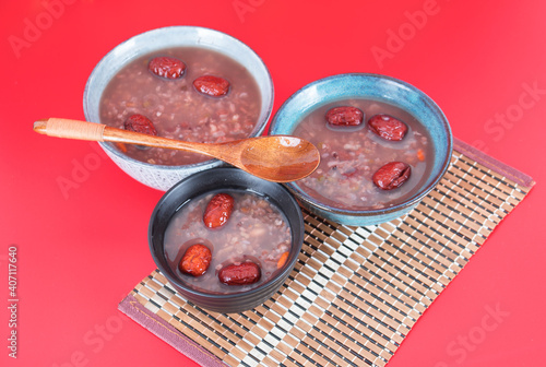 Three bowls of eight treasures porridge on a red background photo