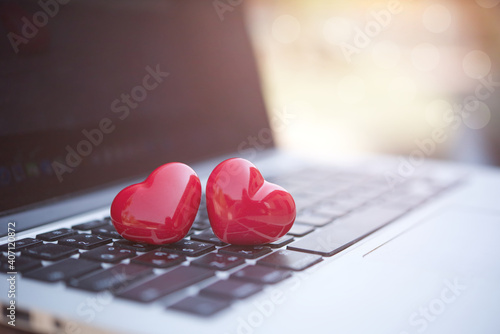 Valentines day concept. hearts on the computer keyboard with soft light background.