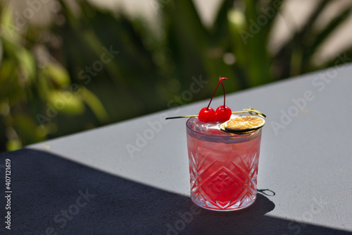 Red Summer Fruity Fresh cocktail outside with cherries. Great on it's own, for social media or for a poster. photo