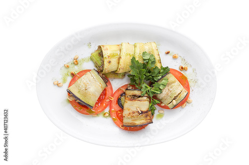 Original serving eggplants and baked tomatoes. Restaurant service concept. Isolated.