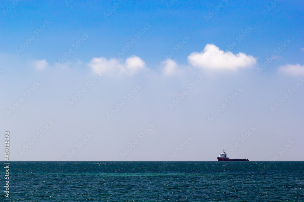 Cargo ship in the blue sea and blue sky background Cargo ship in the blue sea and blue sky background