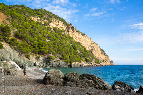 Autumn landscape of Costa Brava on Begur coastline overlooking bay and rocky cliff covered with green trees, Spain.. photo
