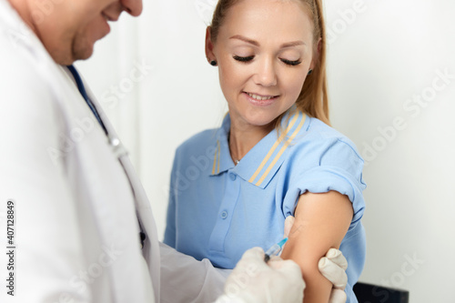 Fototapeta Naklejka Na Ścianę i Meble -  the doctor makes an injection into the hand of a hospital health patient vaccination