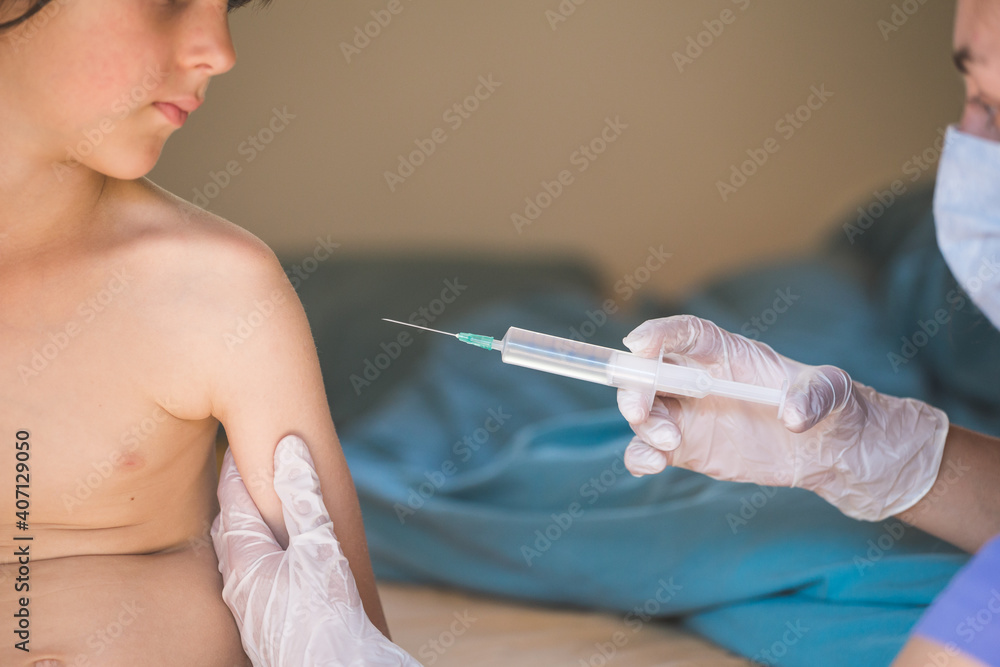 The child is given an injection in the shoulder. The child is given an injection in the shoulder.