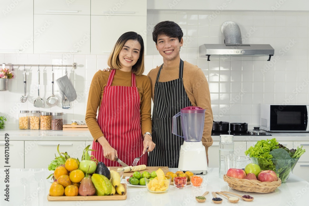 Portrait asian man and woman couple family preparing healthy food and beverage together with smile and happy emotion in modern kitchen room Portrait asian man and woman couple family preparing healthy food and beverage together with smile and happy emotion in modern kitchen room