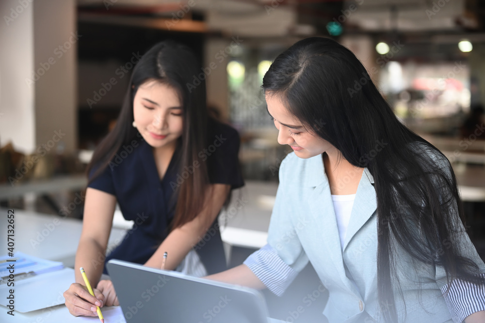 Two young woman working on the new design project in the modern coworking space. Two young woman working on the new design project in the modern coworking space.