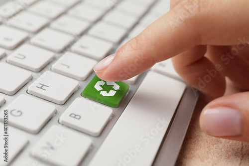 Woman pressing key on keyboard, closeup. Ecology concept photo