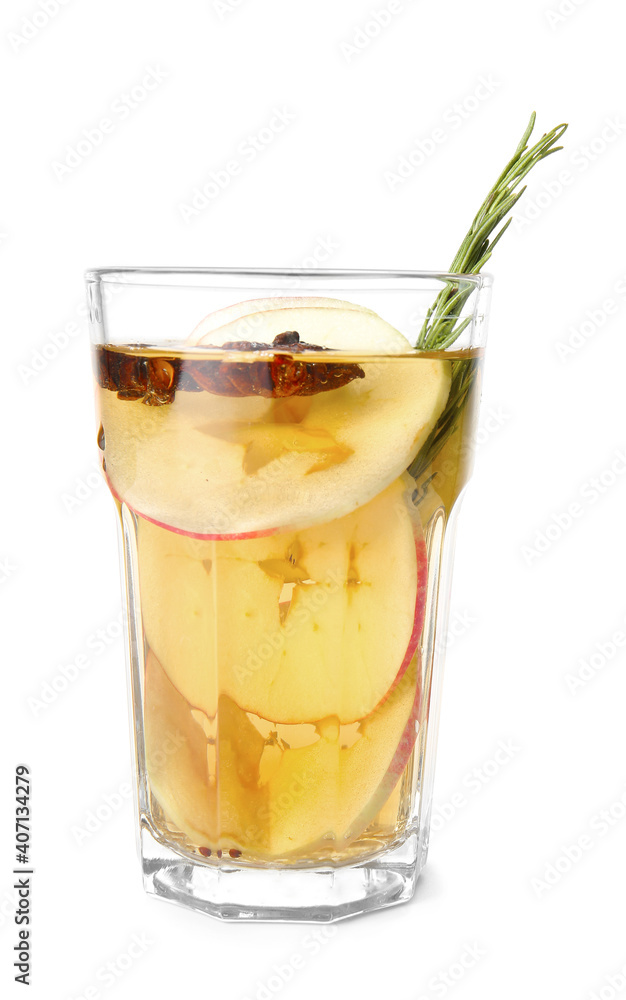 Tasty drink with spices and apple slices in glass on white background Tasty drink with spices and apple slices in glass on white background