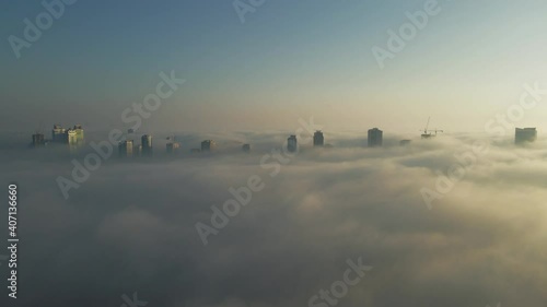 Drone view of Fog over Sharjah, Sharjah skyline covered in the winter morning fog, United Arab Emirates, 4K Drone Footage photo