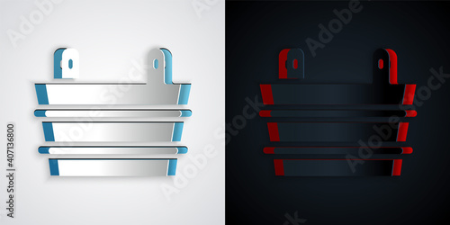 Paper cut Sauna bucket icon isolated on grey and black background. Paper art style. Vector.