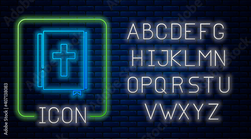 Glowing neon Holy bible book icon isolated on brick wall background. Neon light alphabet. Vector.