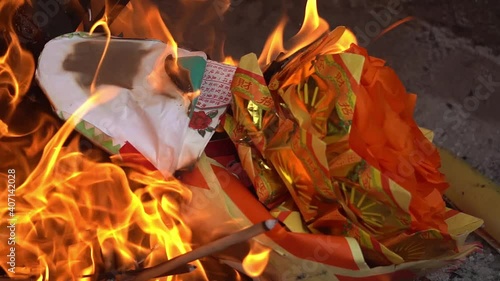 Slow motion burning joss paper at furnace at chinese temple at Penang, Malaysia. photo