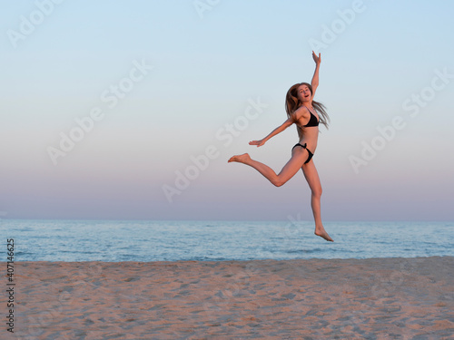 Girl jumping by the sea